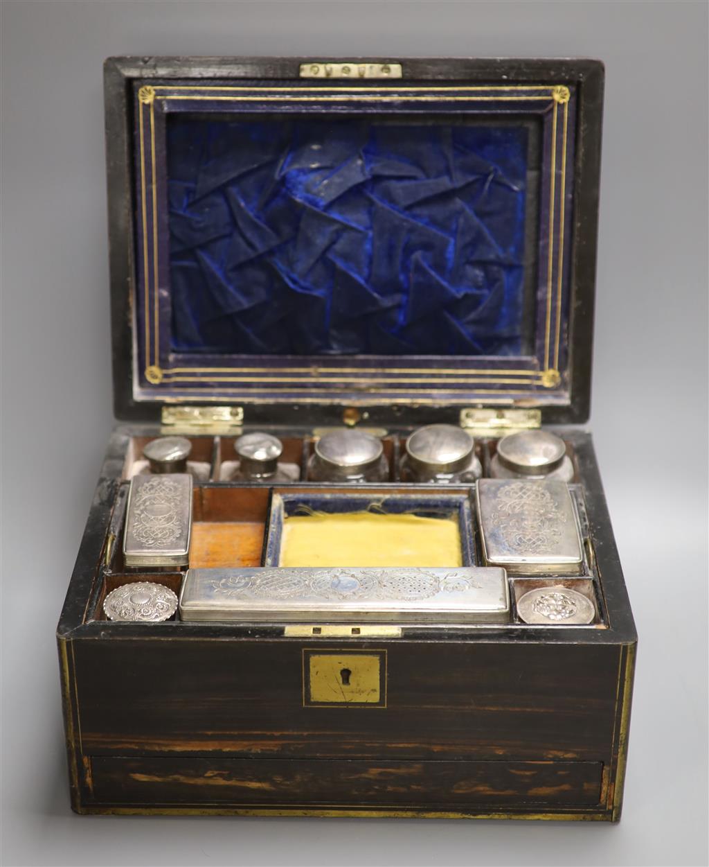 A 19th century brass bound coromandel fitted vanity case and contents, length 31cm
